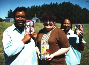 Prison social worker and inmates display Girl Scout cookies.