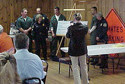 Marion CWP inmates presetn check representing the value of their 2003 work to local communities