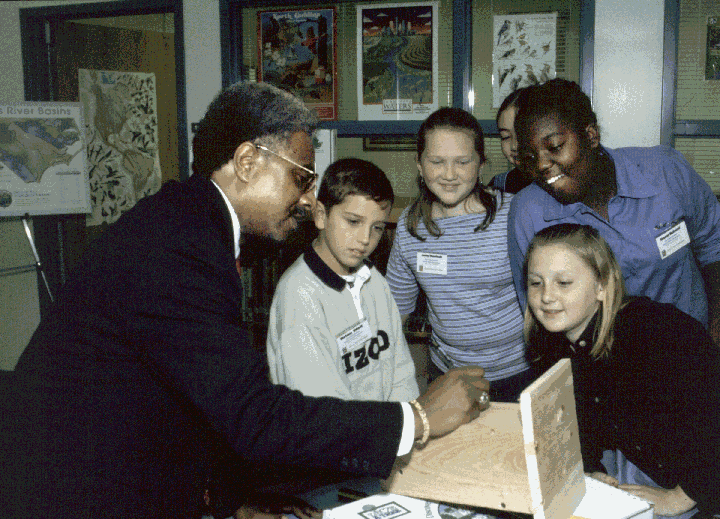 DOC Secretary Theodis Beck assists students at Timber Drive Elementary School in Garner construct blue bird boxes.