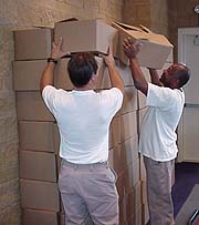 Inmates stack boxes of folded bags, ready for shipment to the newspaper plant