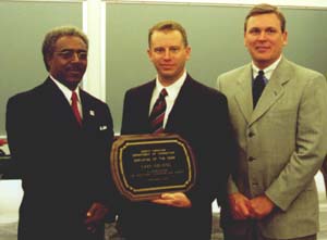 Secretary Theodis Beck and Robert Lee Guy, Director of Community Corrections, present Gary Golding with the Employee of the Year plaque