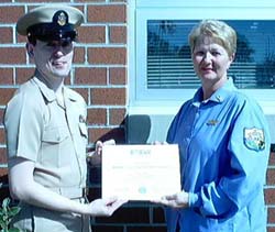Nurse supervisor Lynda Padgett receices her award from a Navy Reserve representative