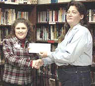 Inmate Vikke Fox presents check to Red Cross representative