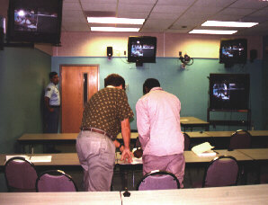 Inmate signs documents after classification hearing via Information Highway.